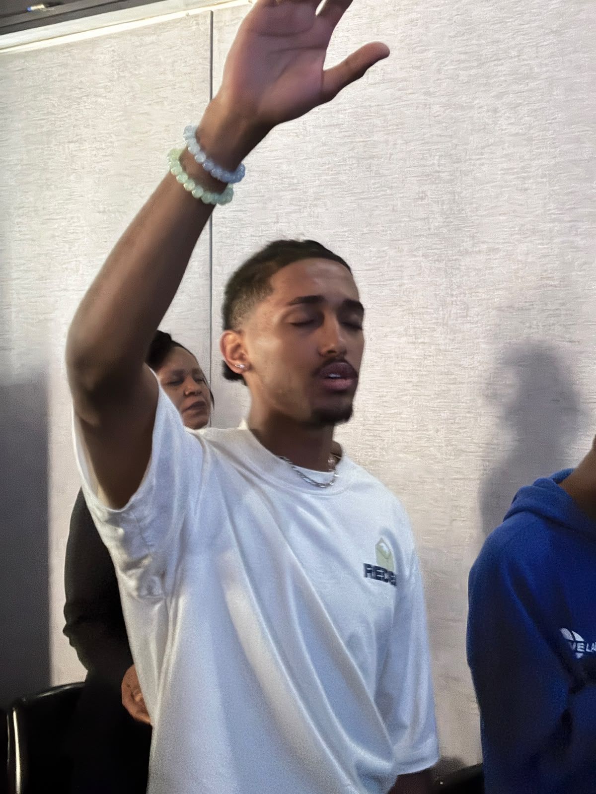 Worshipper with hand raised